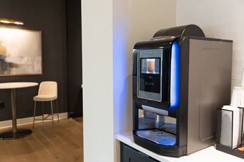 A modern kitchen with a coffee machine on the counter at The Crest at South Point Apartments, Davenport 